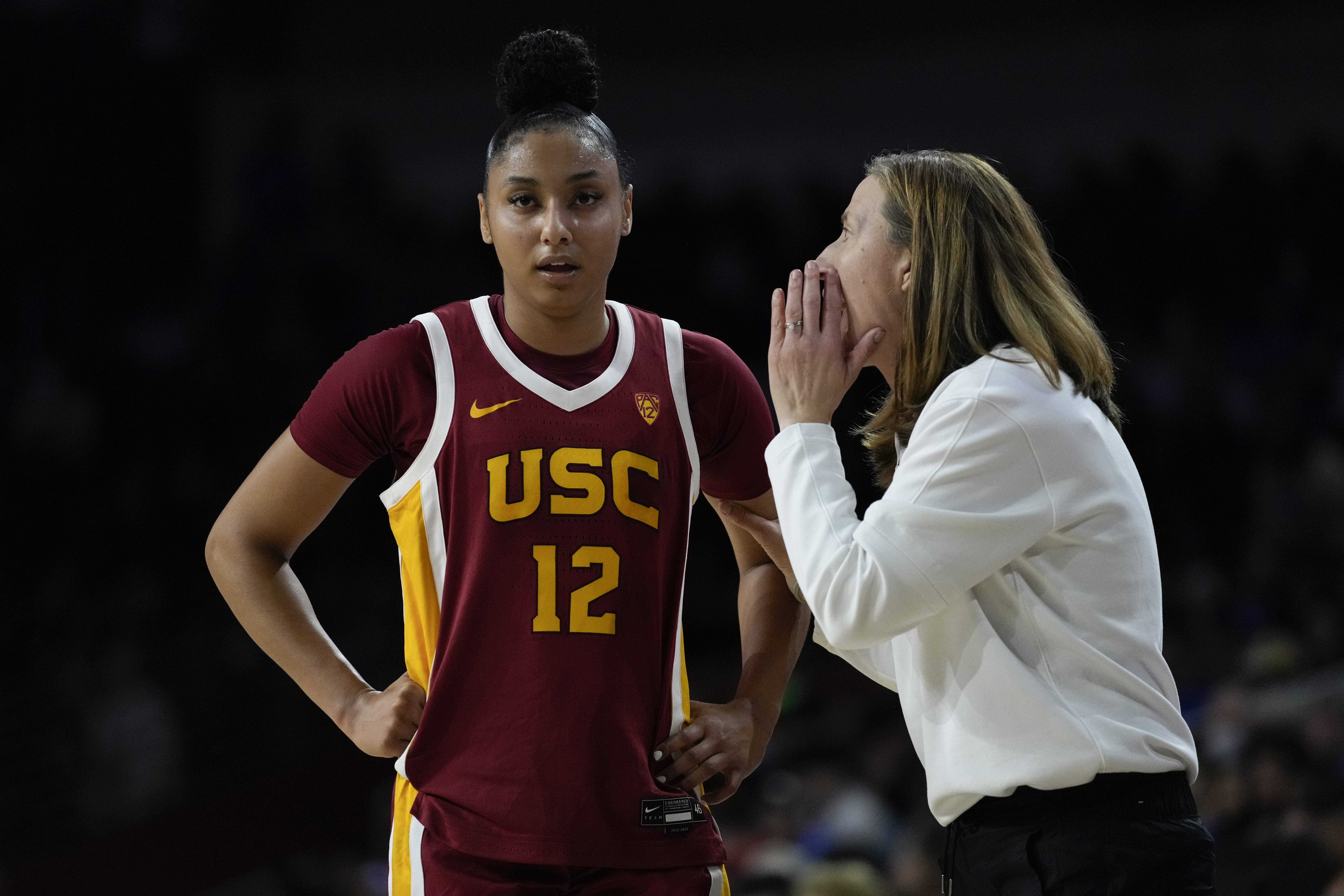 Southern California guard JuJu Watkins (12) talks with head coach Lindsay Gottlieb during the first half of an NCAA college basketball game against UCLA in Los Angeles, Sunday, Jan. 14, 2024. (AP Photo/Ashley Landis)